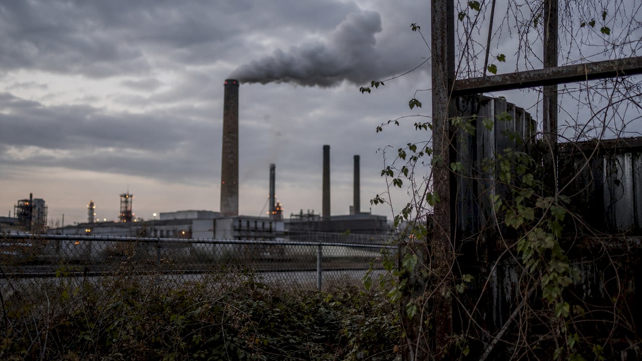 Factory smokestacks releasing pollution smoke