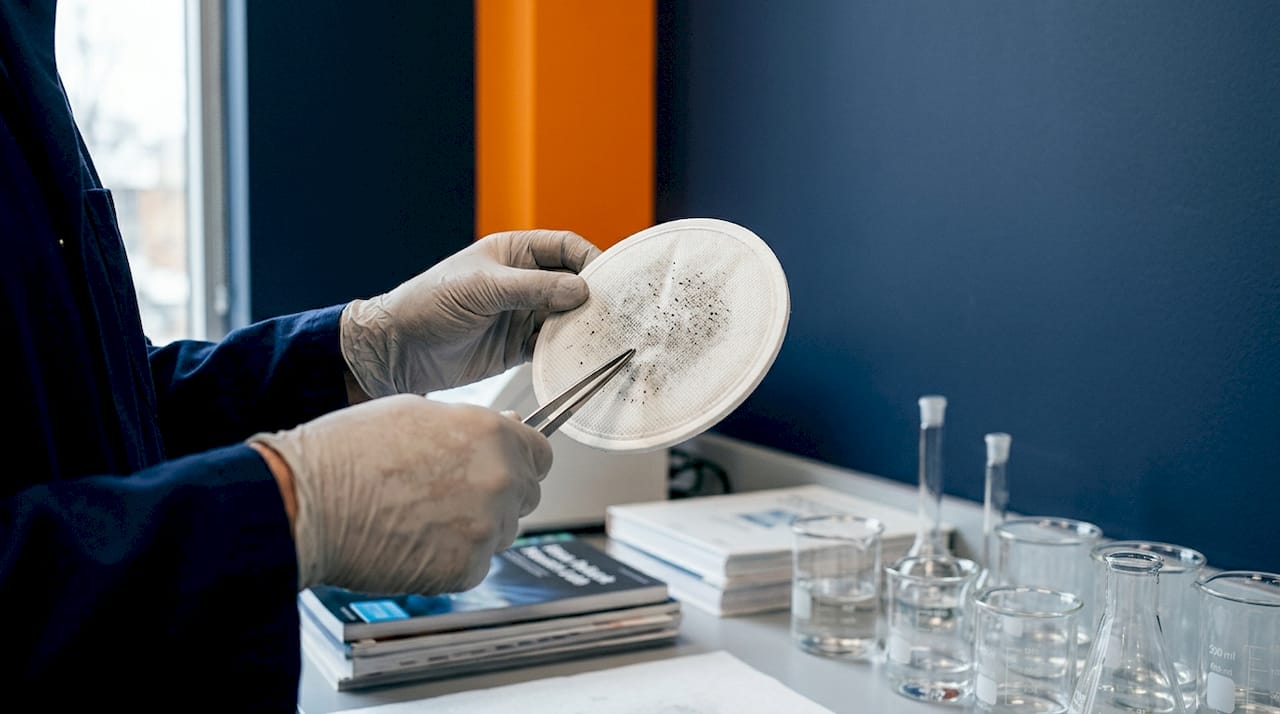 Scientist examining air pollution filter