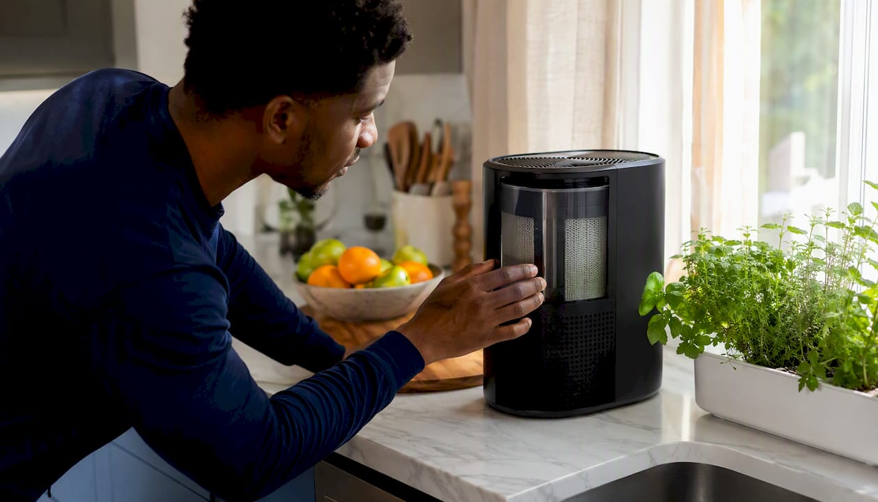 User adjusting air purifier in living room
